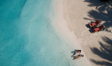 Spacifica Travel InterContinental Bora Bora Resort & Thalasso Spa Couple relaxing on the beach